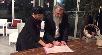 Rabbi David Stav and his wife, Aviva, sign a prenuptial agreement after decades of marriage. Canadian Jewish News.