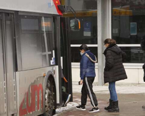 Photo of people lining up to get on a bus operated by Brampton Transit.