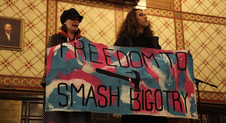 Two women protest at Queen's University.