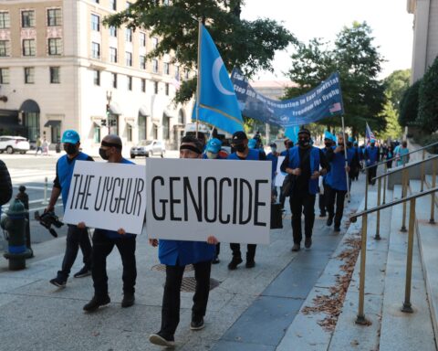 Protesters in Washington, D.C., carry a placard saying "The Uyghur genocide." Uyghurs are targetted by China's transnational repression campaign.