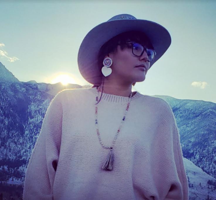 Lambert wearing the earrings and hat she beaded for her sister’s photoshoot of modern Indigenous art.