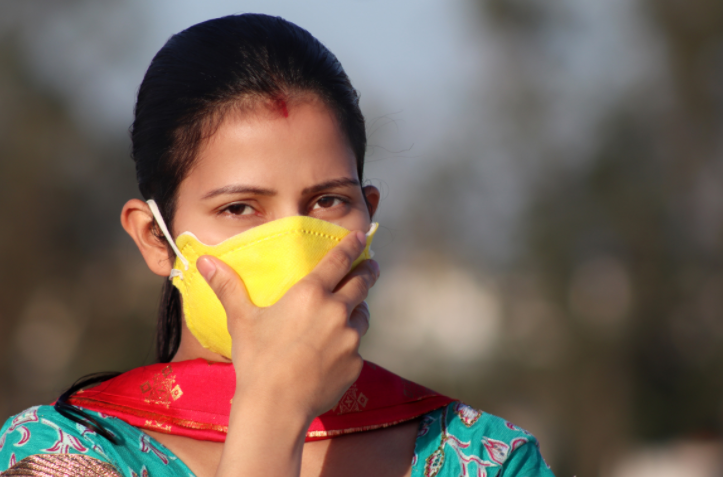 Photo of a South Asian woman wearing a face mask. The Indian COVID-19 crisis is taking a heavy toll on the diaspora too.