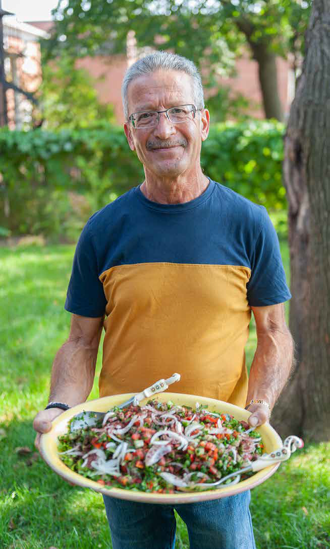 Cook holding a plate of his dish