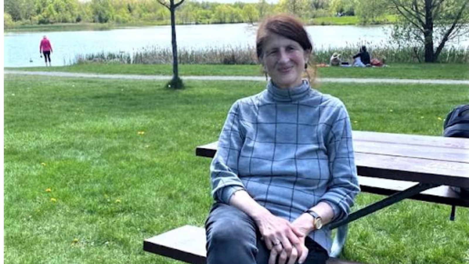 Canadian activist Jill Carr-Harris sits on a park bench.