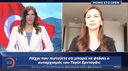 A still of Arzu Yildiz speaking to Greek TV about being included in a hit list of Turkish dissidents.