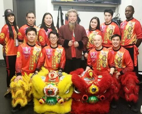 Master of Chinese Dragon and Lion Dance with teammates