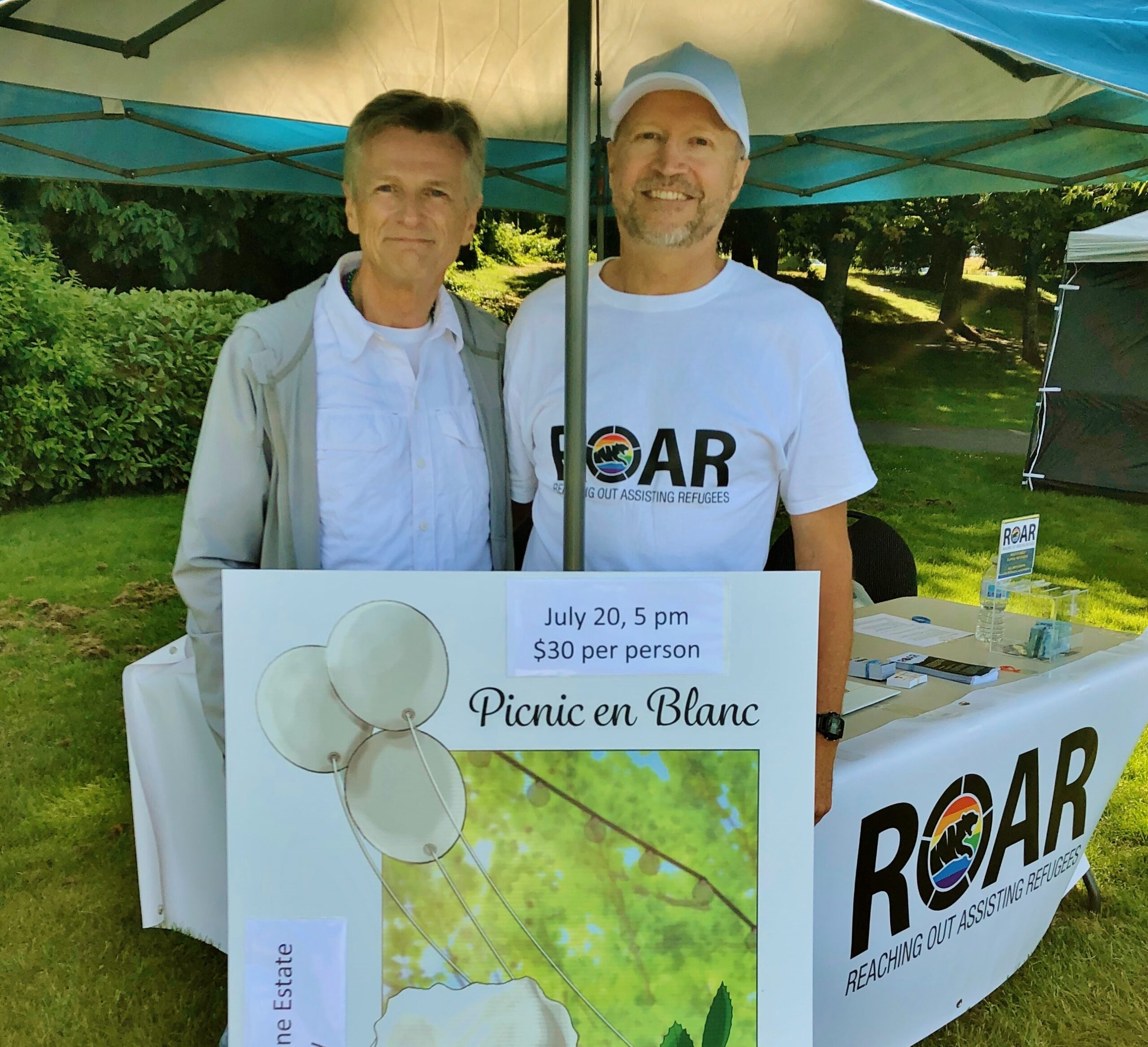 Mark Rabnett (left) and Horst Backé (right) at the ROAR booth at Nanaimo Pride. Credit: ROAR Refugee