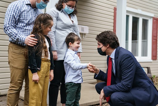 PM Justin Trudeau speaks with families about affordable housing during a visit to Laval