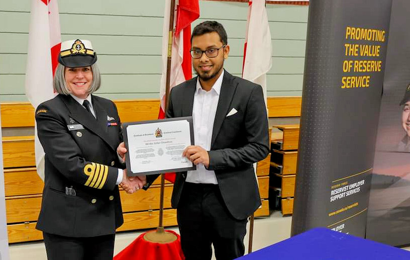 Capt. (Navy) Beth Vallis and Sailor 3rd Class Chowdhury hold up the enrollment certificate during their enrollment on March 8, 2023 at His Majesty’s Canadian Ship, HMCS, Queen Charlotte in Charlottetown, P.E.I. Chowdhury, a native of Bangladesh, became just the second Permanent Resident to enroll in this country’s Armed Forces.