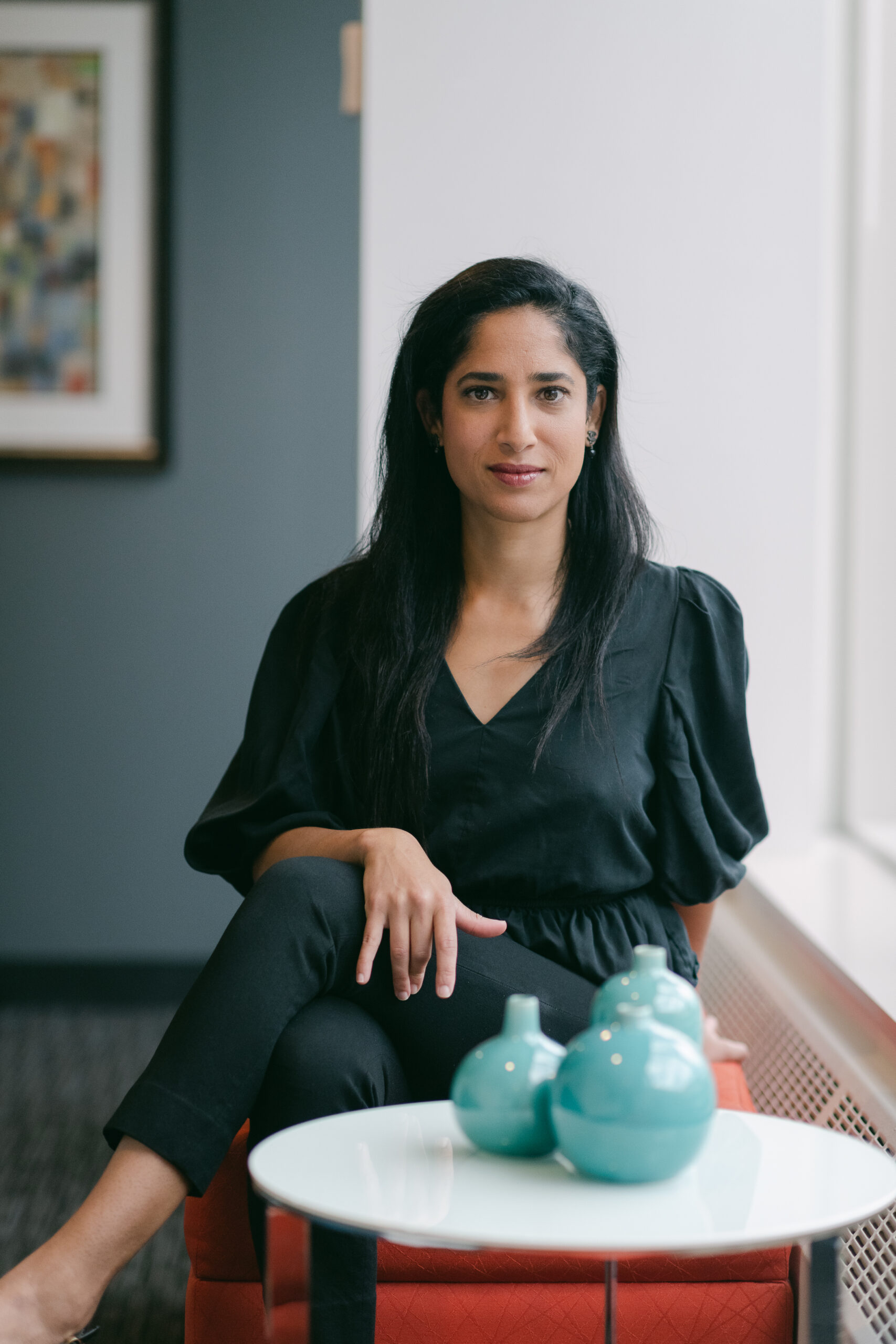 Yameena Ansari, managing lawyer at Ansari Law, seated indoors.