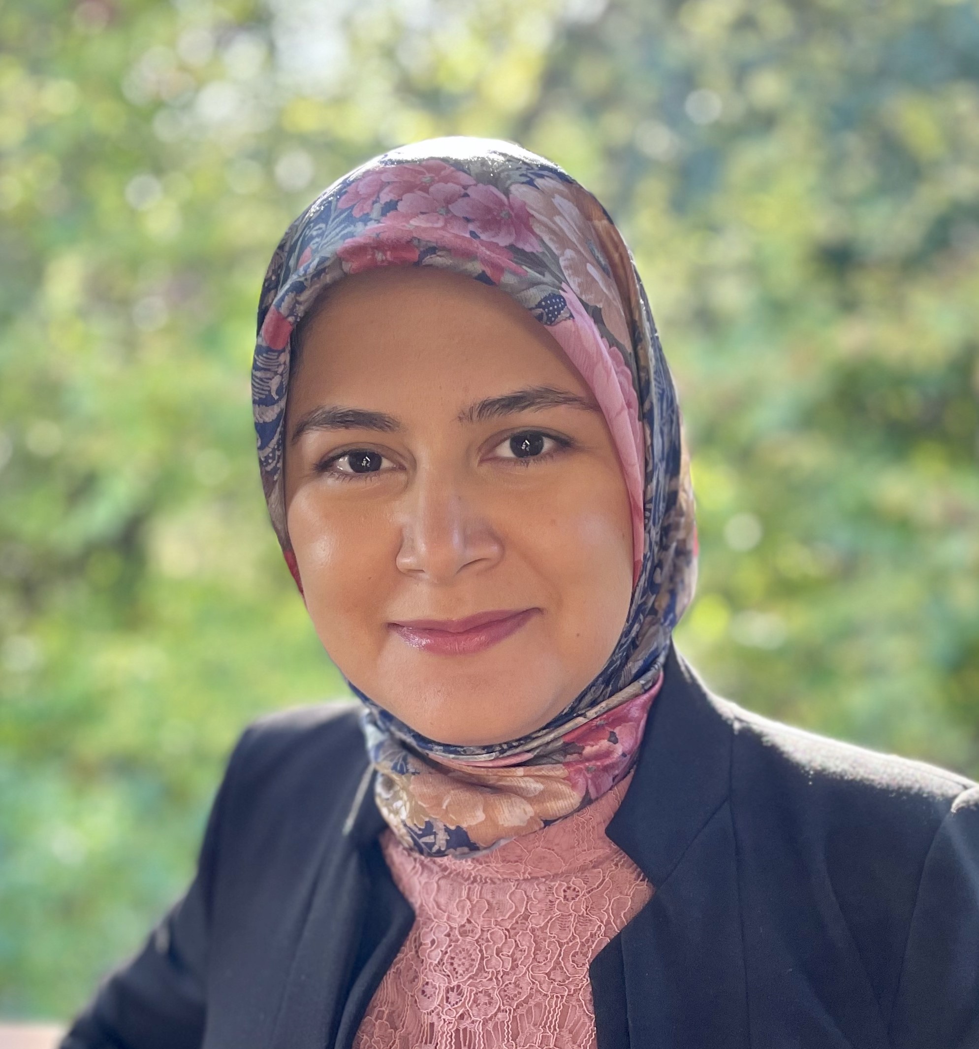 Zeynab Ziaie Moayyed, a certified specialist in citizenship and immigration law, smiling outdoors.
