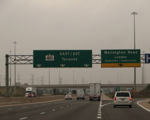 Cars travelling along Highway 401 in London, Ontario, one of Canada's busiest freeways used daily by newcomers navigating the province's auto insurance system.