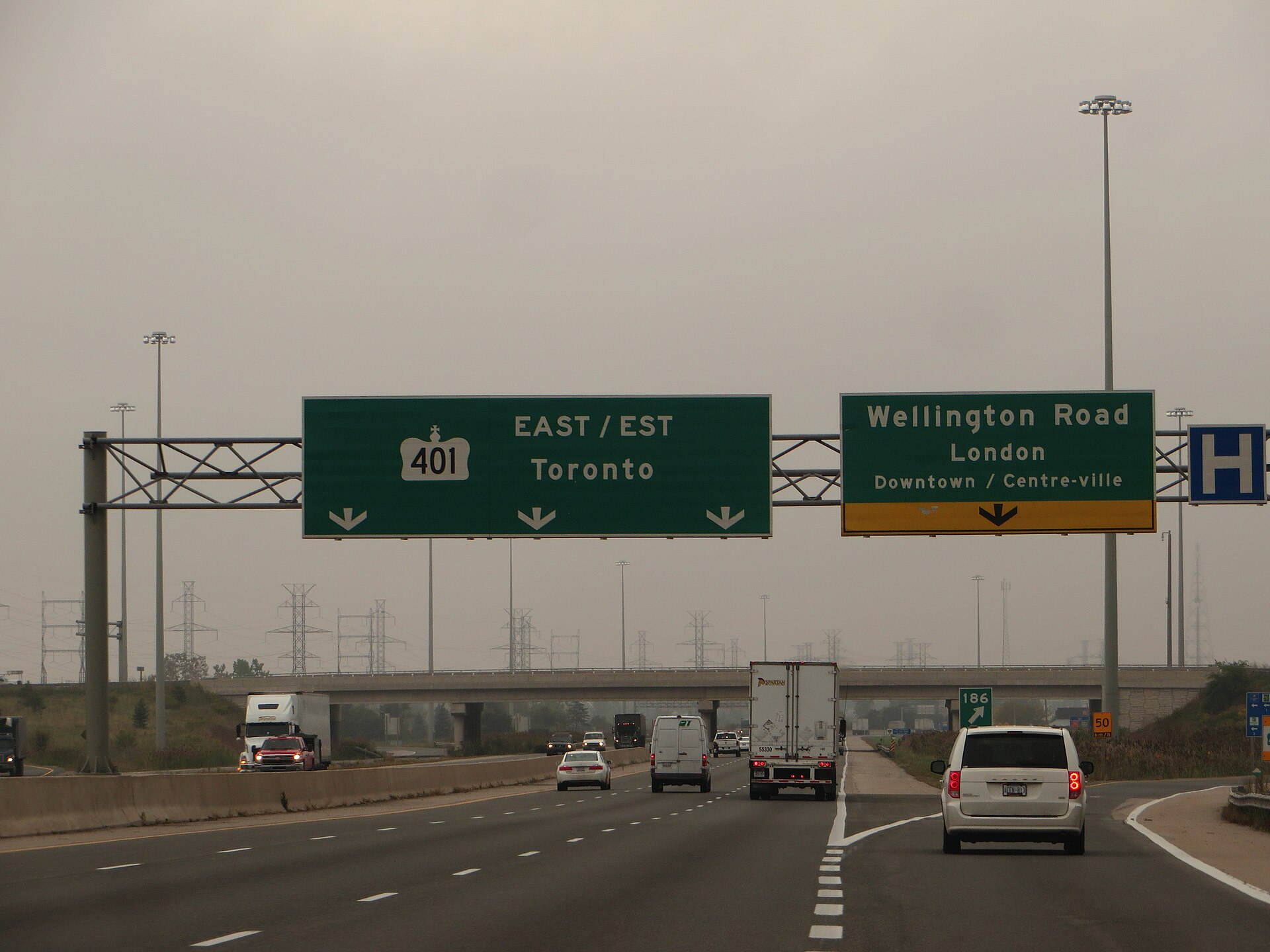 Cars travelling along Highway 401 in London, Ontario, one of Canada's busiest freeways used daily by newcomers navigating the province's auto insurance system.